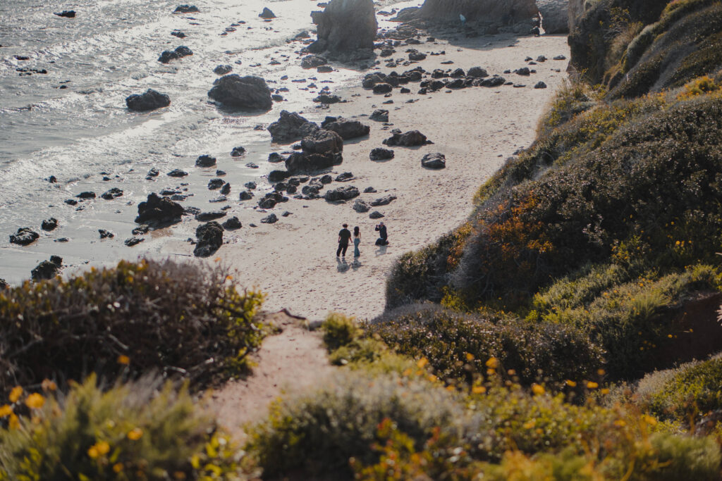 People taking a photoshoot at El Matador Beach in Malibu. Photo by Wayfare With Pierre