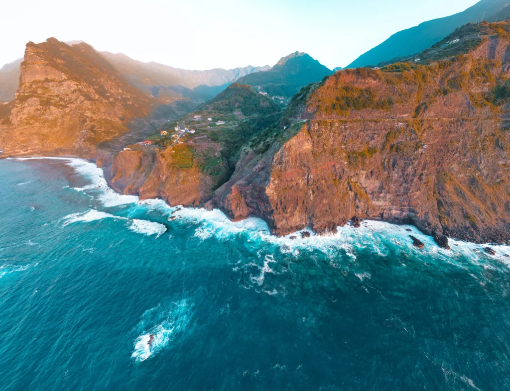 Drone shot of ocean waves and mountains