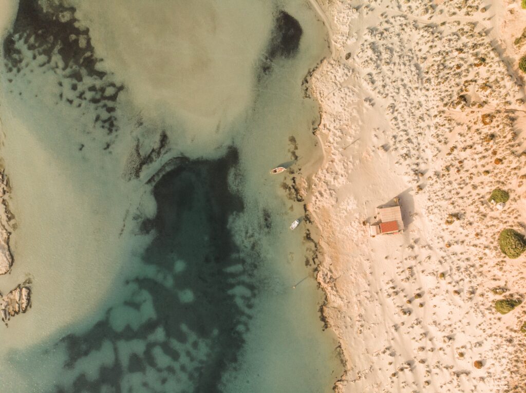 overhead drone photo of boat in water 