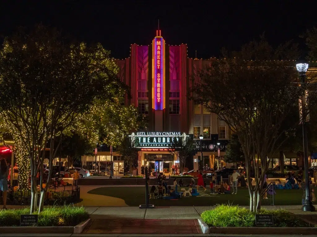 Market Street at night in the Woodlands Texas, with the neon Market Street sign glowing